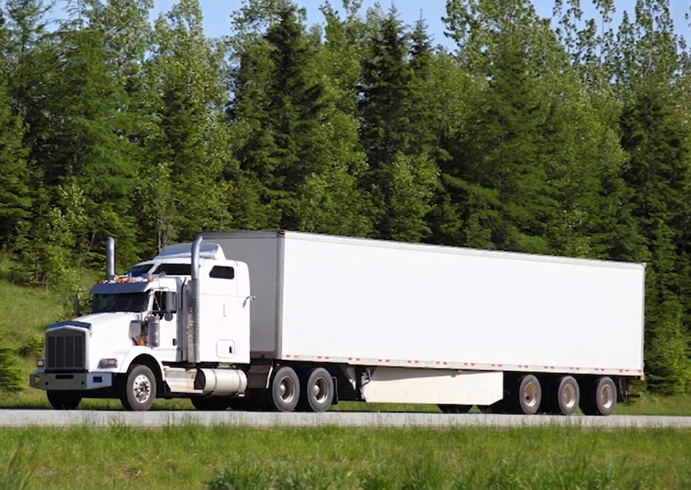 White semi-truck driving on highway